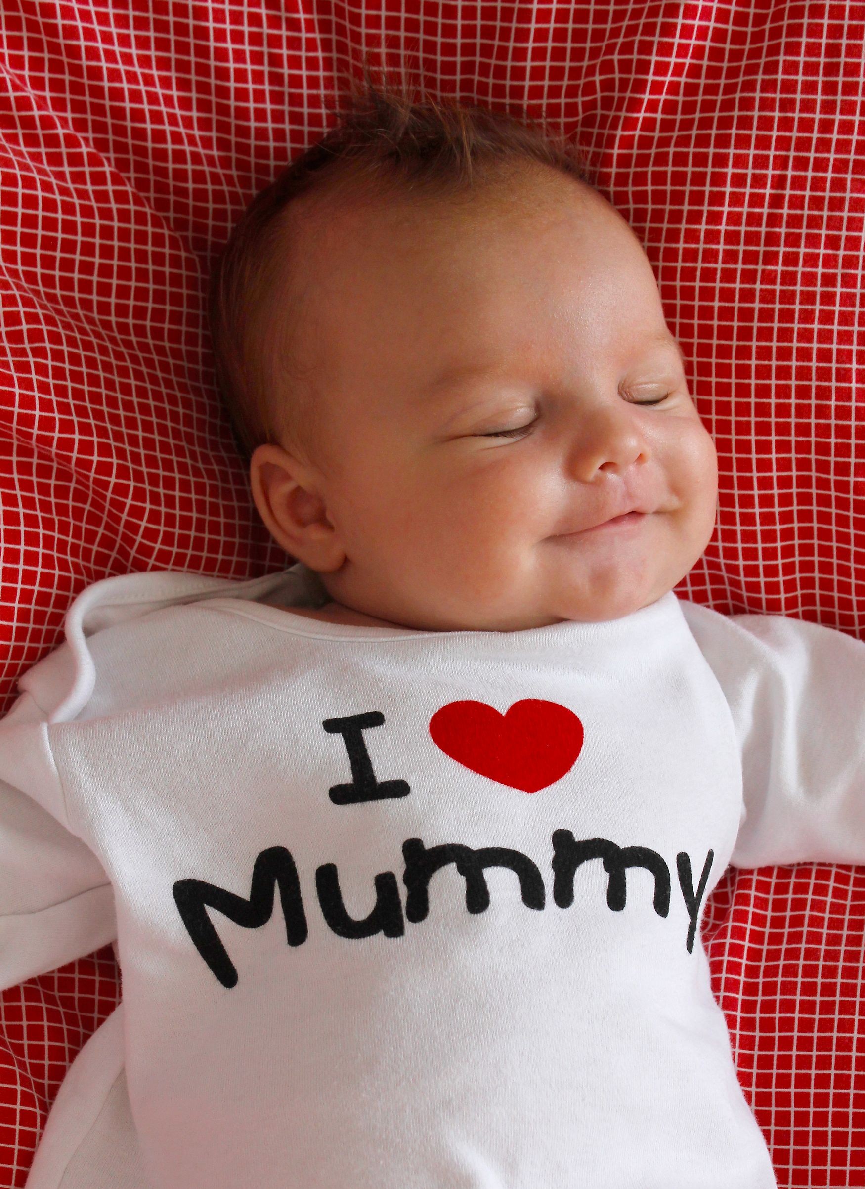 Cute infant boy about 1-2 months old relaxing at home.